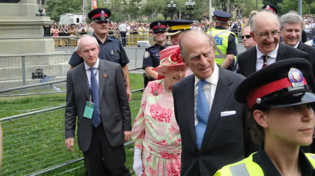 The Queen spots a little girl with a bouquet during a visit to Toronto with husband Philip