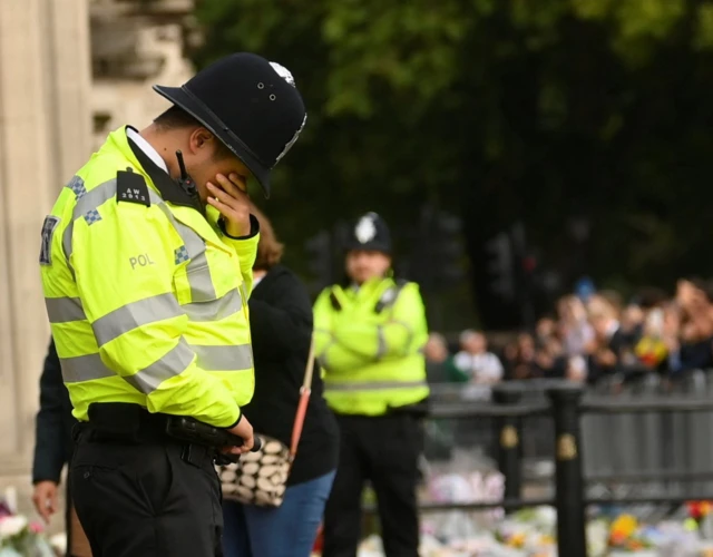 Police officer outside Buckingham Palace