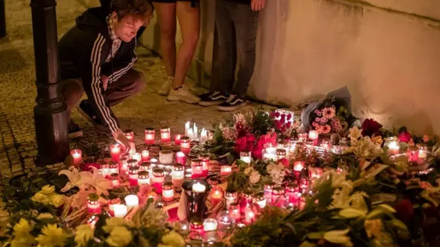 Candles and flowers left in memory of the Queen on a Prague street