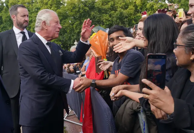 King Charles III is greeted by well-wishers during a walkabout to view tributes left outside Buckingham Palace, London, following the death of Queen Elizabeth II on Thursday. Picture date: Friday 9 September 2022.