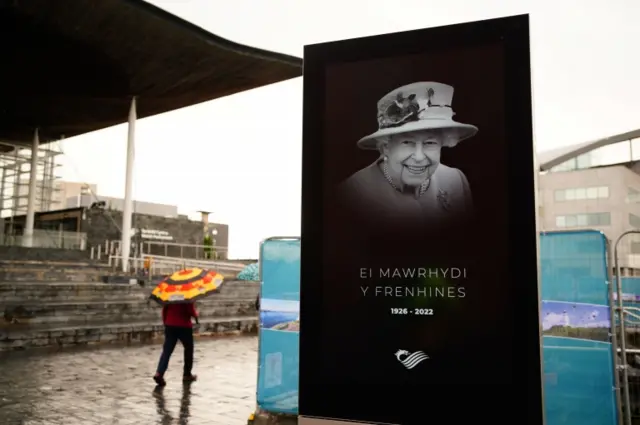 A tribute to Queen Elizabeth II is displayed on a screen outside the Senedd Building in Cardiff