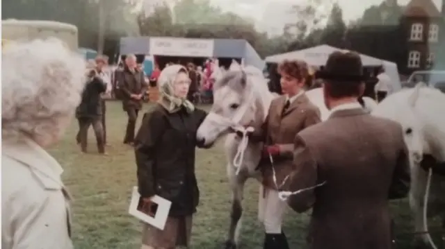 Karen with the Queen and one of her horses.
