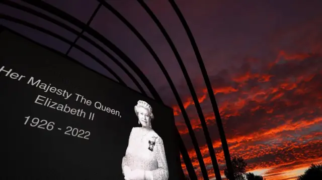 A picture appears as a tribute in memory of Queen Elizabeth II outside Aberdeen airport