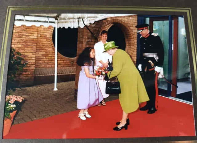 Sheena Jones gives the Queen a bouquet of flowers