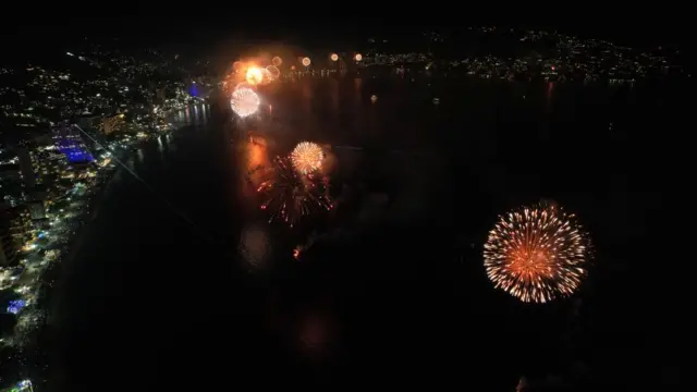 A photograph taken with a drone shows fireworks illuminate the night sky over the Balneario resort city during New Year's celebrations in Acapulco, Mexico, on 1 January 2023