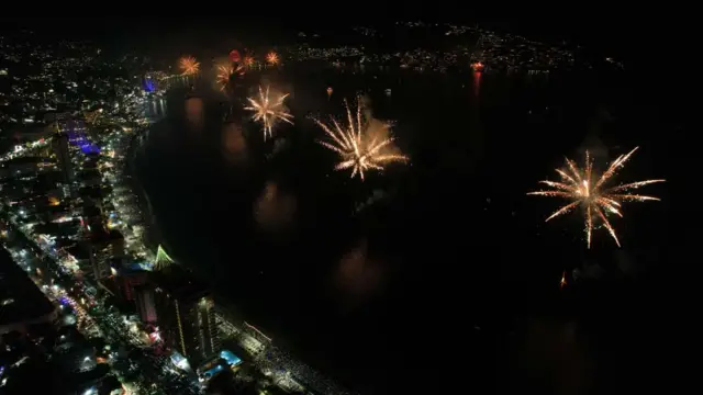 A photograph taken with a drone shows fireworks illuminate the night sky over the Balneario resort city during New Year's celebrations in Acapulco, Mexico, on 1 January 2023