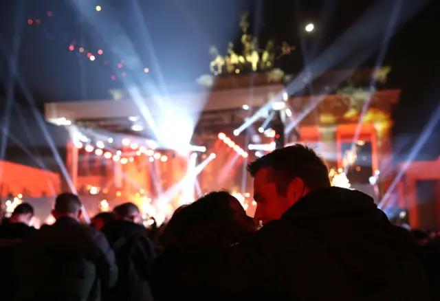 Two people share a New Year kiss at the Brandenburg Gate in Berlin
