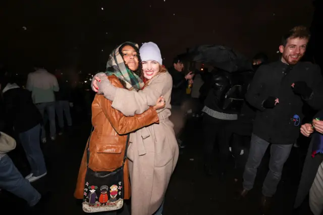 Two women hug
