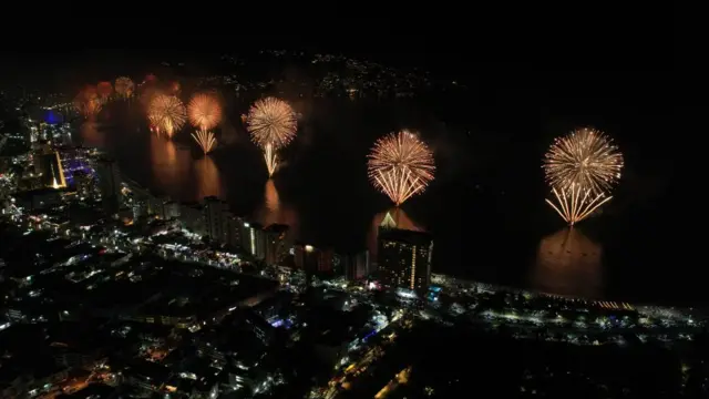 A photograph taken with a drone shows fireworks illuminate the night sky over the Balneario resort city during New Year's celebrations in Acapulco, Mexico, 1 January 2023