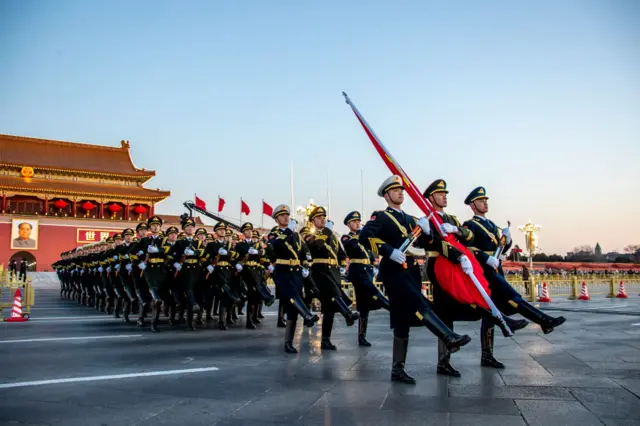 The Chinese People's Liberation Army (PLA) escorts the national flag during a flag-raising ceremony at Tiananmen Square