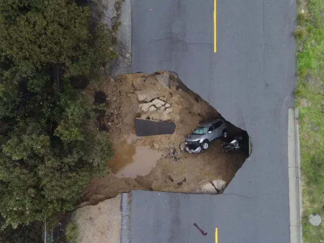 Two people had to be rescued after their vehicle fell into a sinkhole in Chatsworth, California