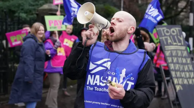 Protesters on a primary school teachers picket line outside Wellshot Primary School in Glasgow, as primary schools around Scotland are shut during strike action by members of the EIS and NASUWT union