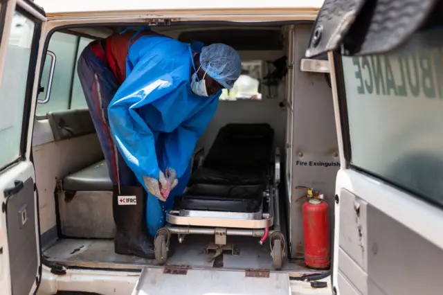 ed Cross workers clean ambulances after transporting Ebola victims to hospital on October 13, 2022 in Mubende, Uganda.