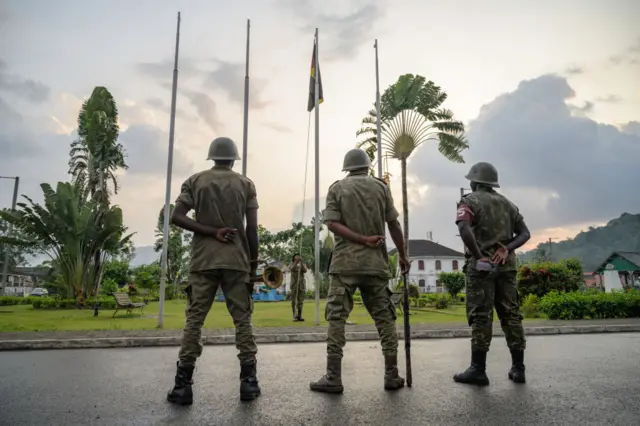 Soldiers lowering the flag of Sao Tomé e Principe during the traditional daily sunset ceremony