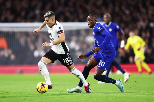 Andreas Pereira is challenged by Dennis Zakaria