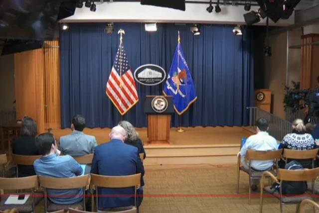 An empty stage before Garland's address