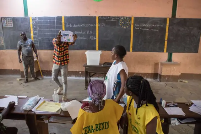 Members of the observers and the CENA (Commission Electorale Nationale Autonome) check the number of votes following the legislative elections at the public primary school,