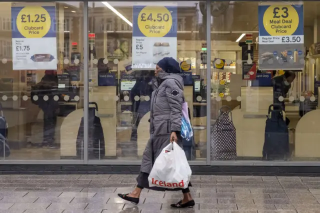 Woman walking outside tesco