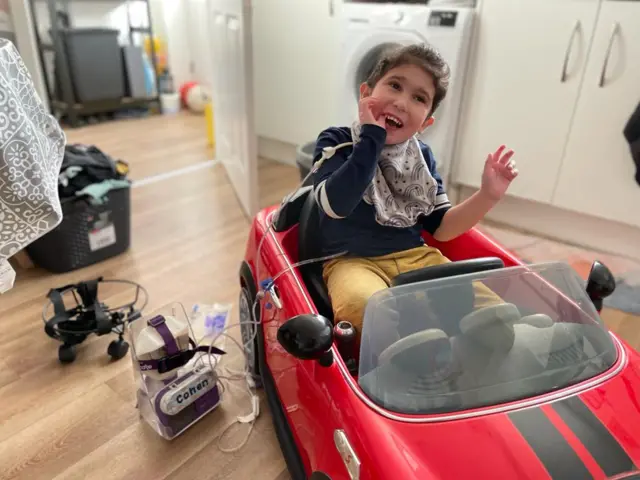 Cohen in his toy car