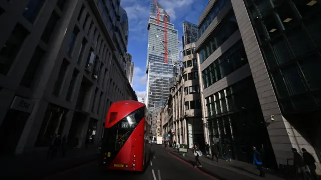 A bus drives through the financial district of London