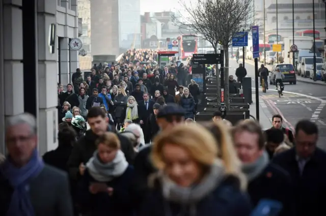 General view of city workers walk across London Bridge during rush hour