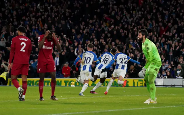 Danny Welbeck wheels away to celebrate Brighton's third goal against Liverpool.