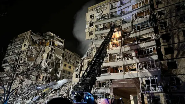 Rescuers work at the site where an apartment building was heavily damaged by a Russian missile strike, amid Russia's attack on Ukraine, in Dnipro