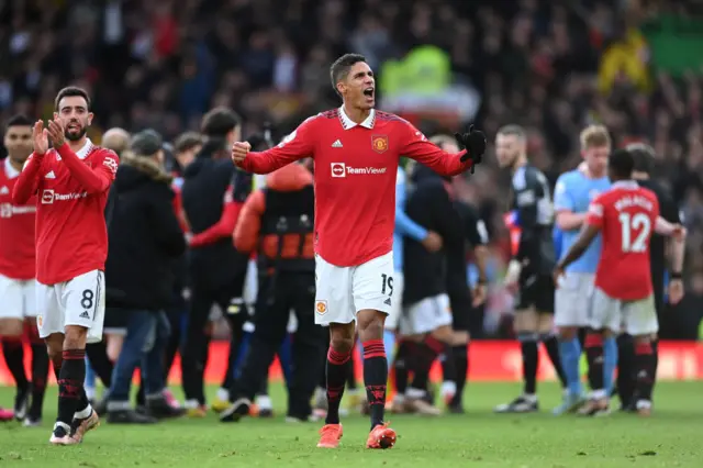 Raphael Varane celebrates Man Utd's derby win over rivals Man City.