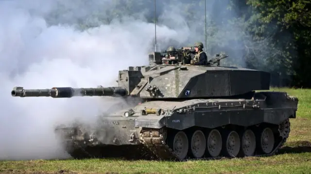 Challenger 2 main battle tank uses smoke to camouflage the tank during a demonstration for the families watching The Royal Tank Regiment Regimental Parade, on September 24, 2022 in Bulford, England