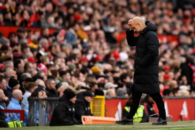 Man City boss Pep Guardiola scratches his head in frustration.