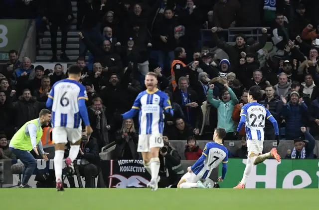 Solly March celebrates scoring his second goal against Liverpool.