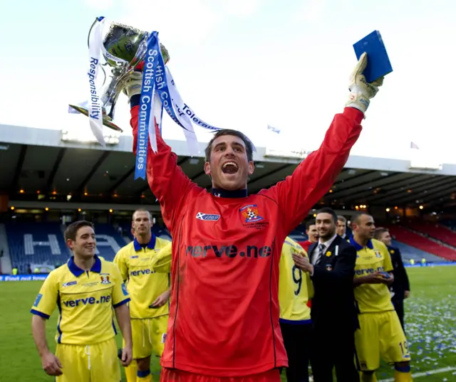 Cammy Bell holds the League Cup aloft in 2012