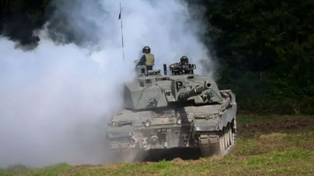 Challenger 2 main battle tank uses smoke to camouflage the tank during a demonstration for the families watching The Royal Tank Regiment Regimental Parade, on September 24, 2022 in Bulford, England