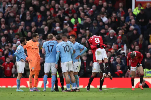 Man City players complain to the referee after Bruno Fernandes controversial goal stands.