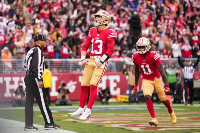 Brock Purdy celebrates scoring a touchdown