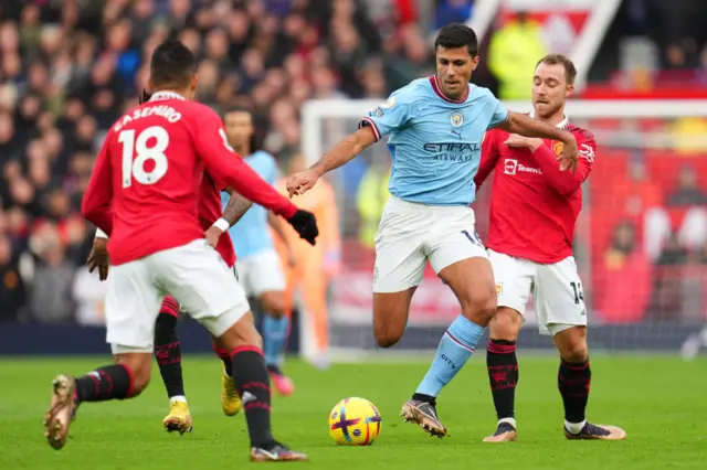 Man City's Rodri is swarmed by the Man Utd midfield duo of Casemiro and Christian Eriksen.