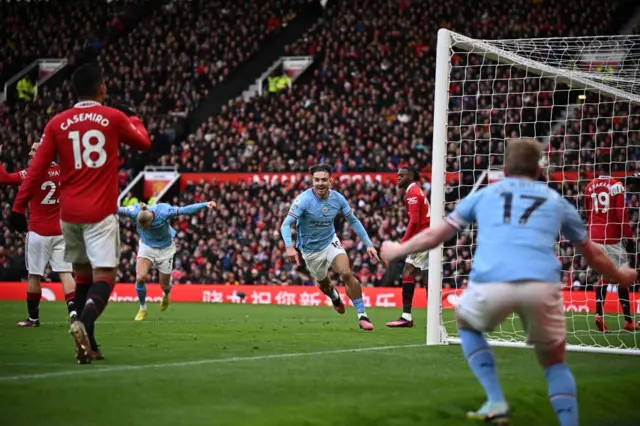 Jack Grealish smiles in delight after putting Man City in front against Man Utd.