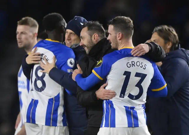 Brighton manager Roberto de Zerbi celebrates with his players after their win.