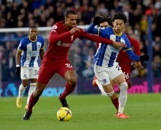 Liverpool's Joel Matip tries to block off Brighton forward Mitoma.