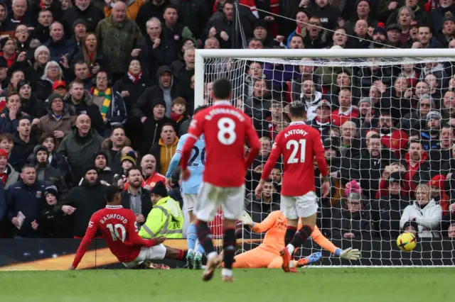 Marcus Rashford pokes the ball home to put Man Utd ahead against Man City.