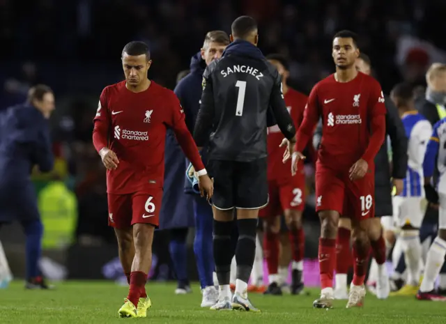 Liverpool players trudge away after their heavy defeat to Brighton.