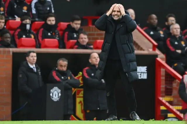 Man City boss Pep Guardiola shakes his head in anger.