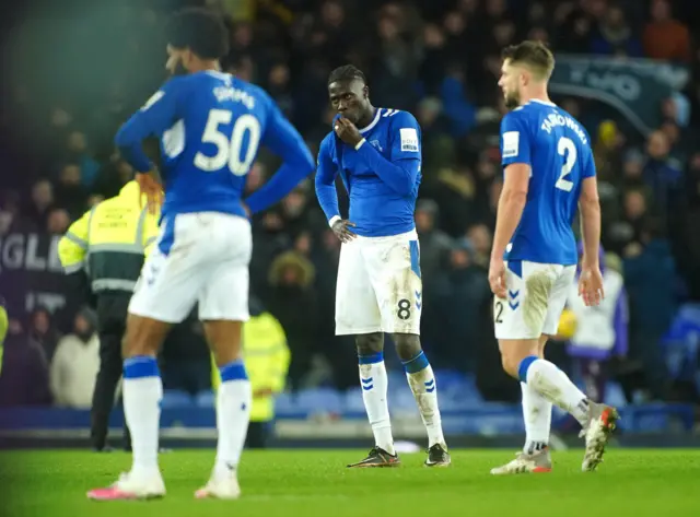 Everton players stand in the middle of the pitch after their latest defeat.