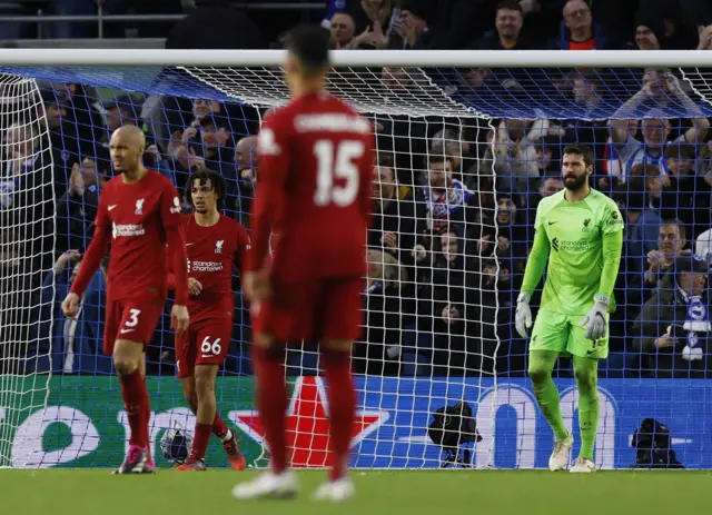 Liverpool players look shellshocked after conceding a second goal against Brighton.