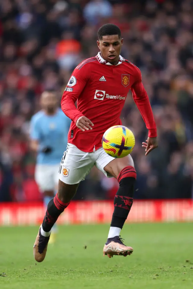 Man Utd forward Marcus Rashford sprints downfield with the ball.