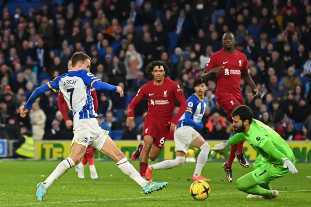 Solly March puts Brighton ahead against Liverpool.