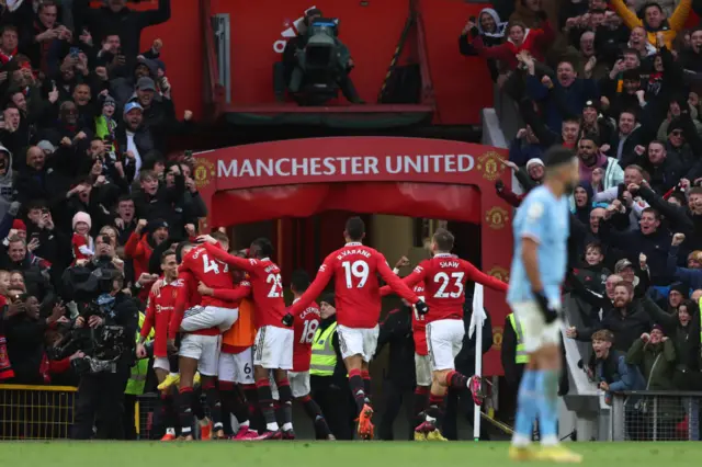 Man Utd players celebrate going ahead against Man City.