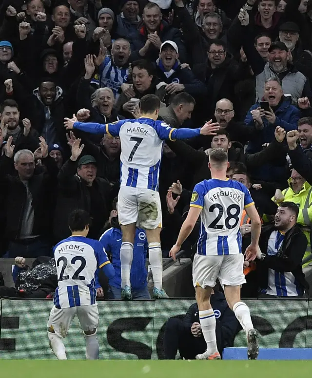 Solly March celebrates with the Brighton fans after scoring his second goal.