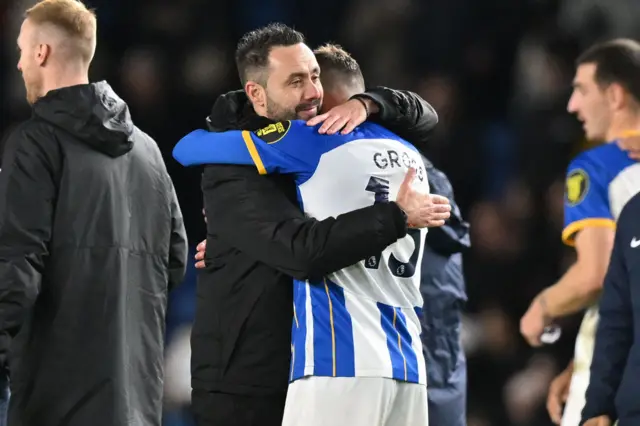 Brighton boss Roberto de Zerbi hugs Pascal Gross after the side's victory.