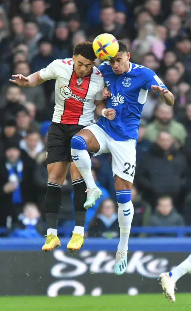 Ben Godfrey of Everton challenges in an aerial duel.